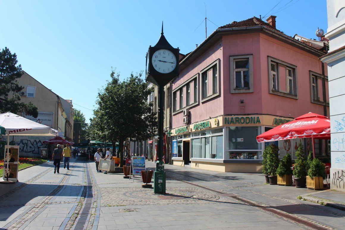The Korzo with its street clock, café umbrellas and people walking