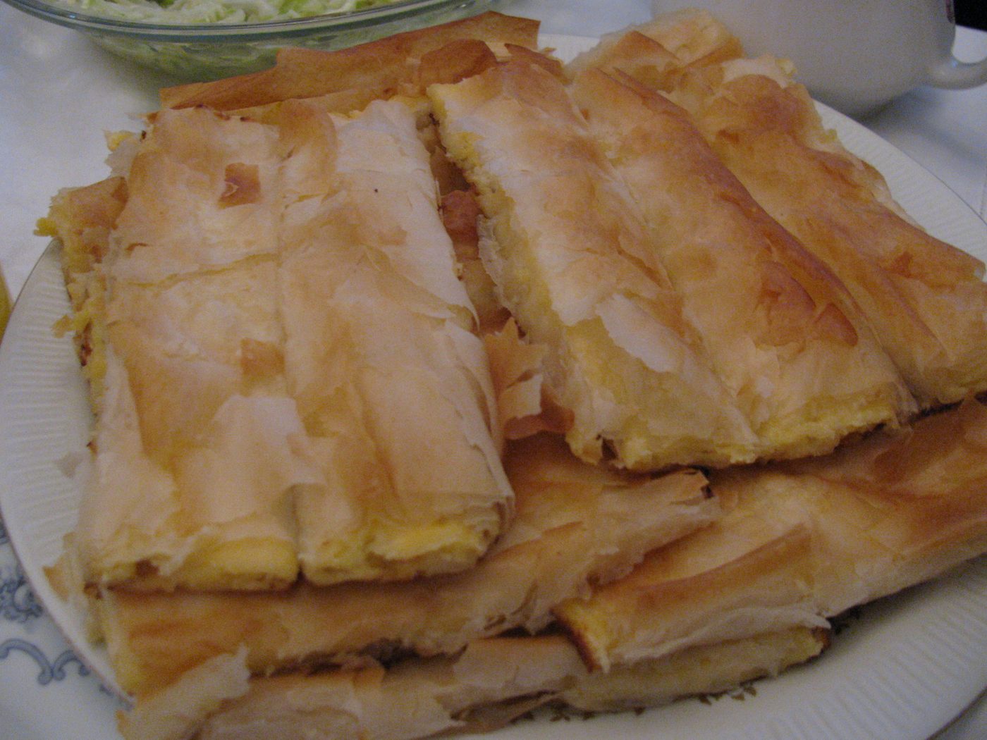 Squares of flaky cheese pie on a plate